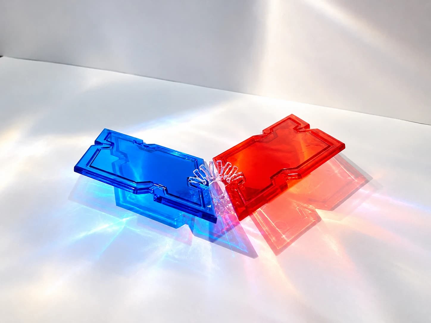 A blue Rhomboi and a red Rhomboi joined by a snowflake connector