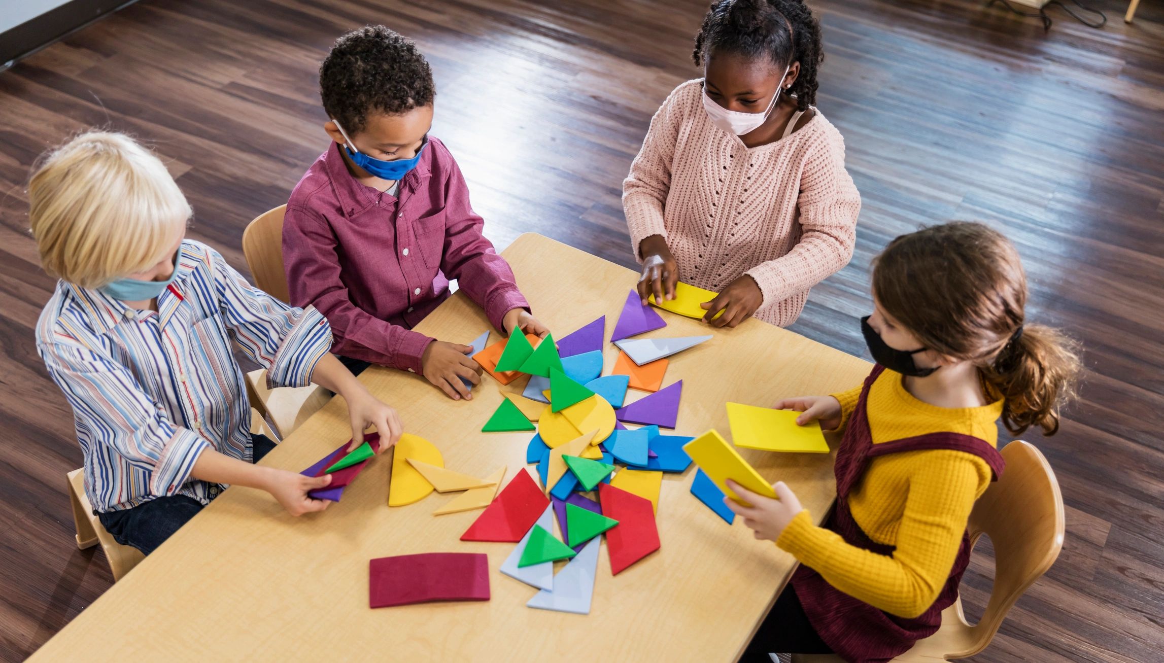 children playing with geometric toys
