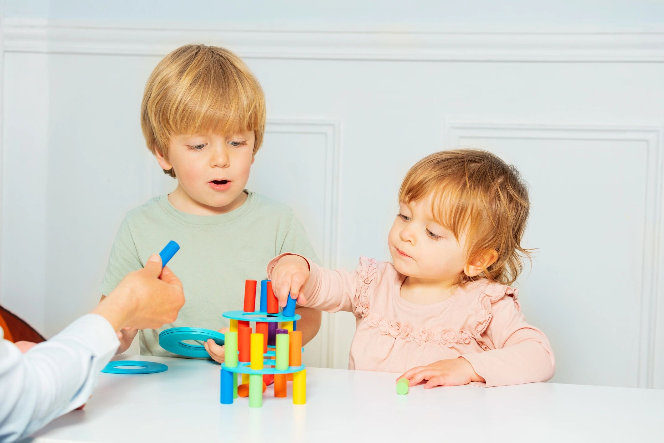 children playing with educational toy geometry shapes