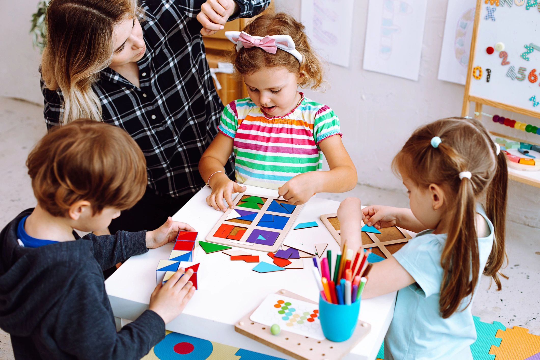children playing with educational toy geometry shapes