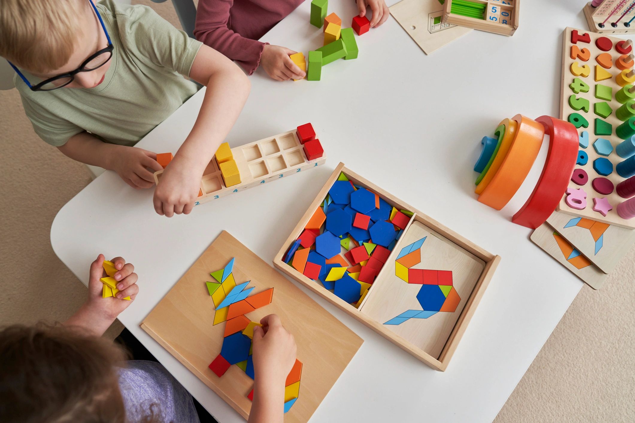 children playing with educational toy geometry shapes