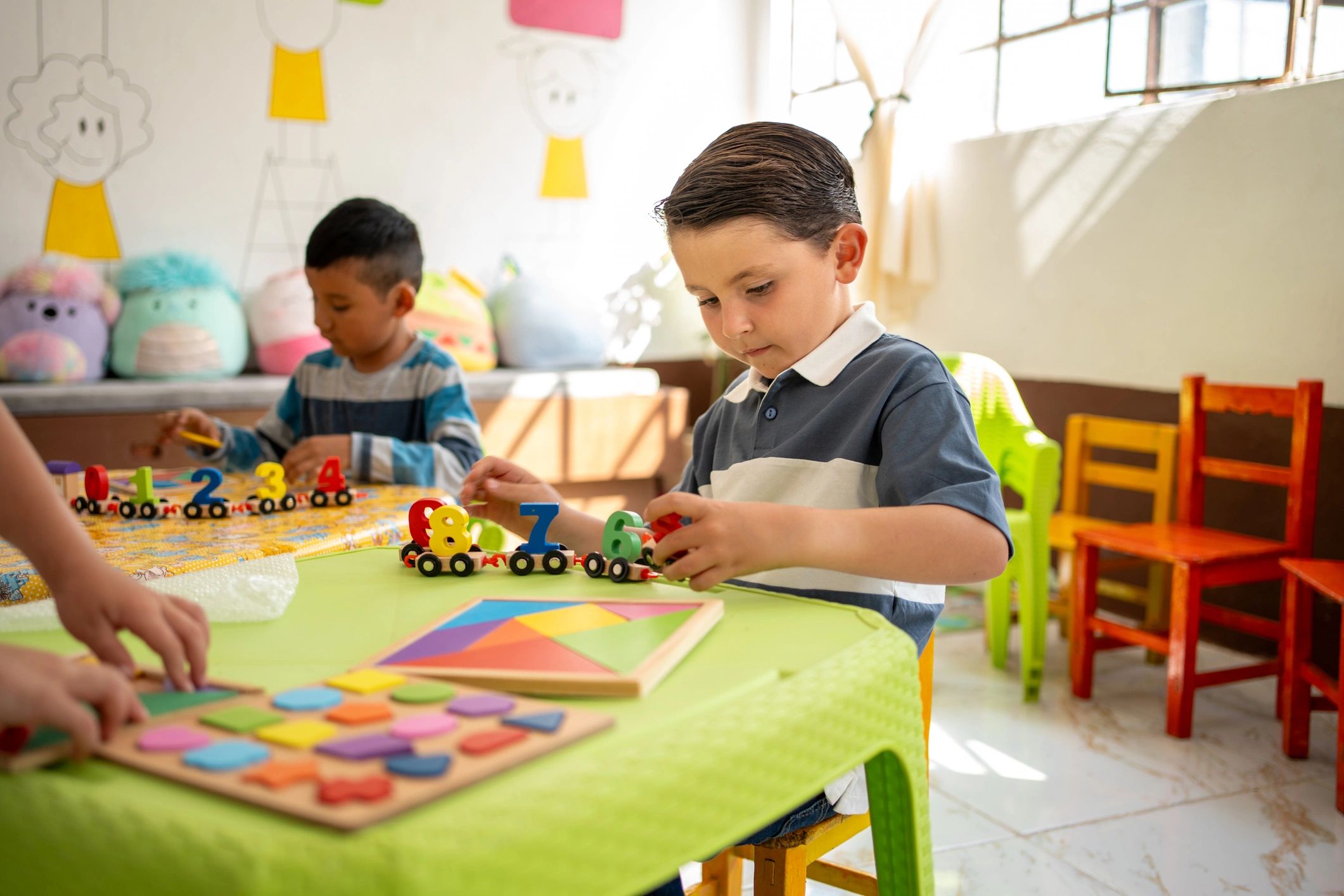 children playing with educational toy geometry shapes