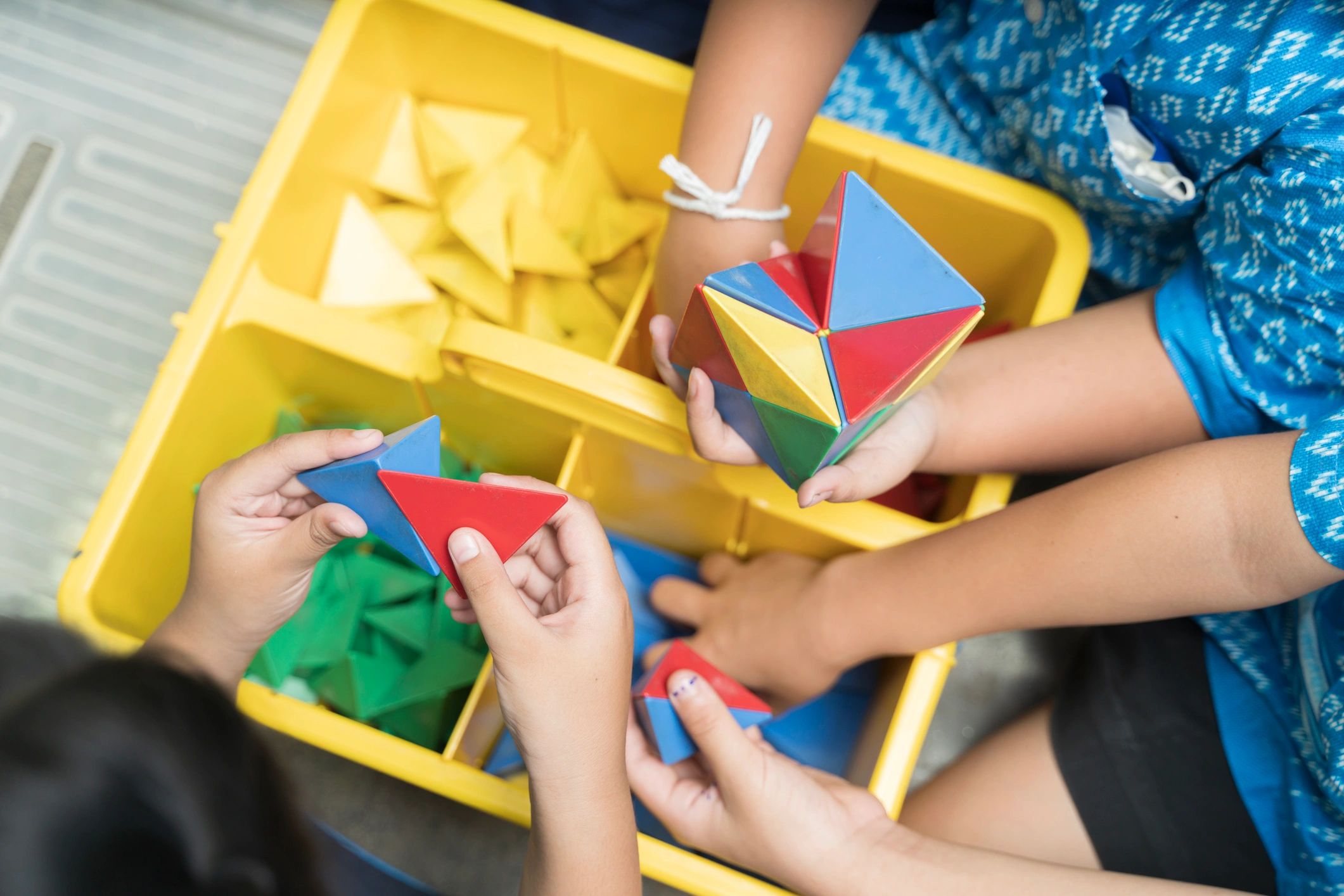 children playing with educational toy geometry shapes