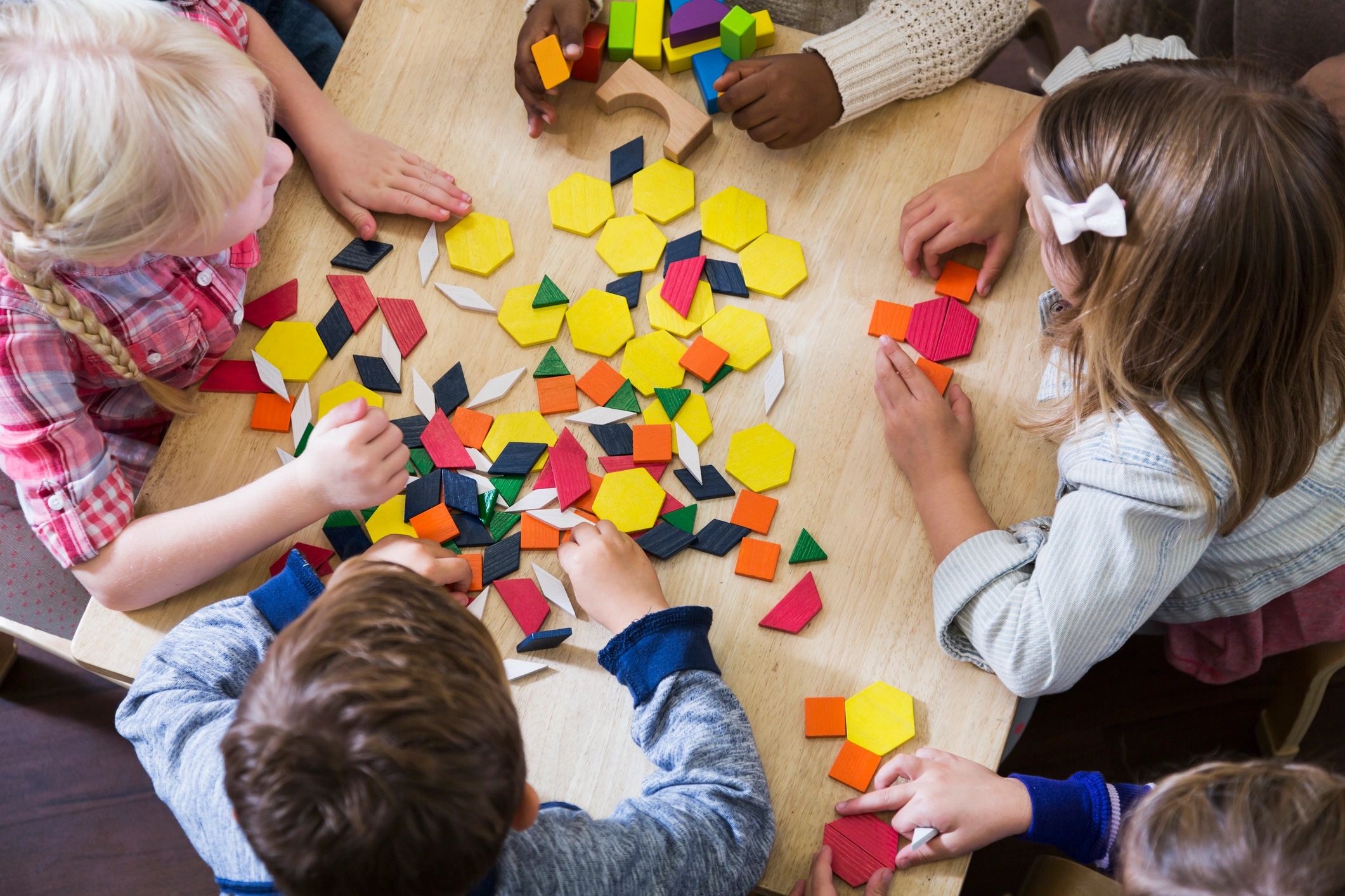 children playing with geometric toys
